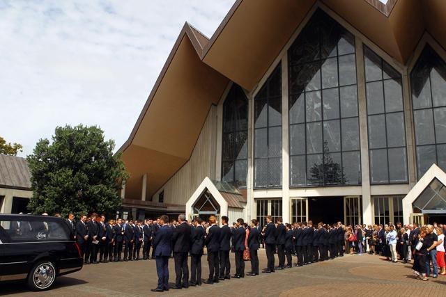 A guard of honour for the hearse is formed outside the Holy Trinity Cathedral in Auckland. (AFP Photo)