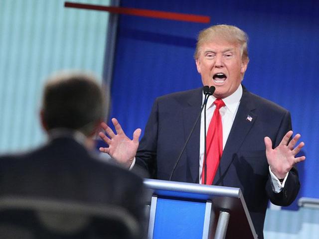 Republican presidential candidate Donald Trump reacts as presidential candidate SenatorTed Cruz rebukes a comment made by him during the Republican debate at the University of Miami on Thursday.(AP)