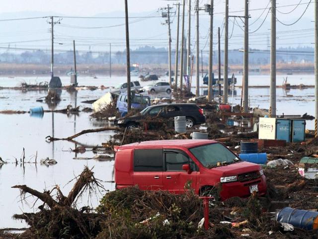 This March 12, 2011 photo shows cars and debris littering an area of Sendai city after a monster tsunami unleashed by a massive quake wreaked destruction across northeast Japan. (AFP File Photo)