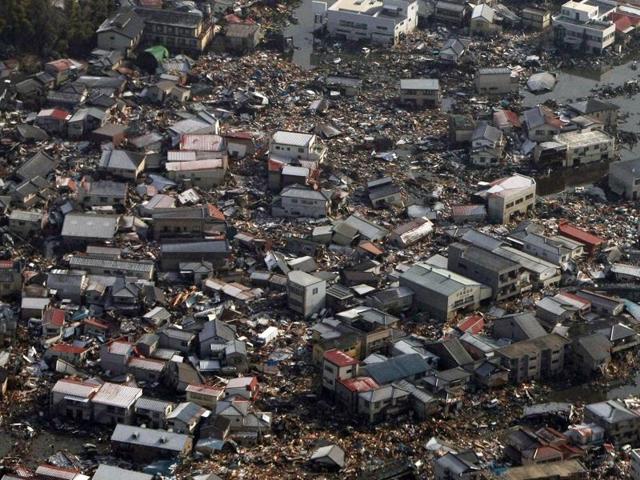 Collapsed houses and debris in a field in Kesennuma, Miyagi prefecture on March 12, 2011. (AFP File Photo)