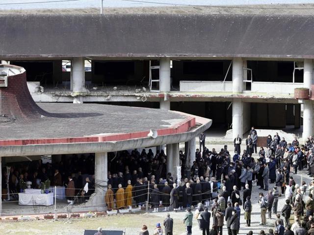 People observe a moment of silence at 2:46pm at Okawa elementary school where more than 70 students and teachers went missing after the 2011 earthquake and tsunami, in Ishinomaki. (AP Photo)