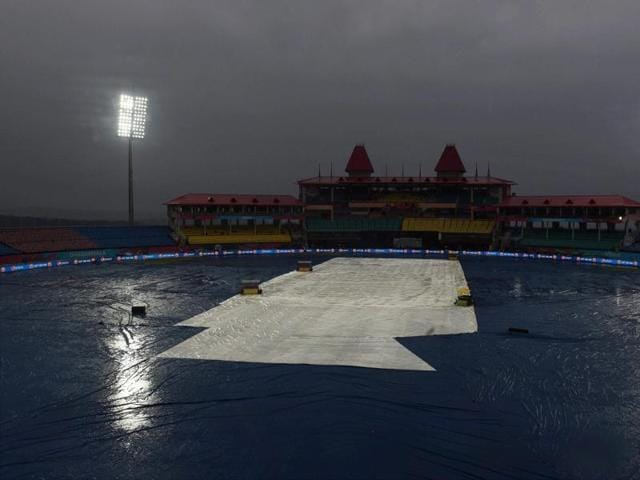 The ground is covered as it rains during the T20 World Cup match between Oman and Netherlands in Dharamshala. (PTI Photo)