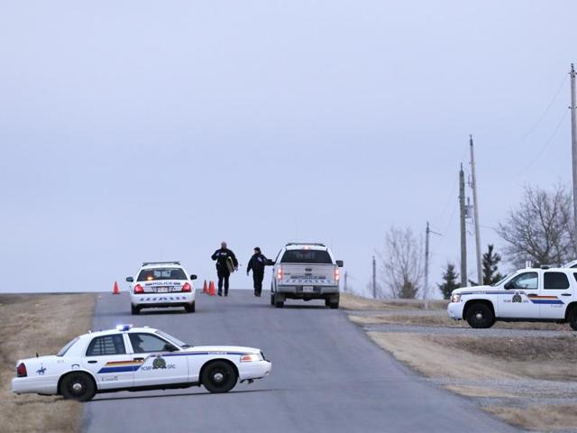 Royal Canadian Mounted Police (RCMP) officers man a road block leading to a Muslim cemetery near Cochrane, Canada. (AP Photo) Royal Canadian Mounted Police (RCMP) officers man a road block leading to a Muslim cemetery near Cochrane, Canada. (AP Photo)