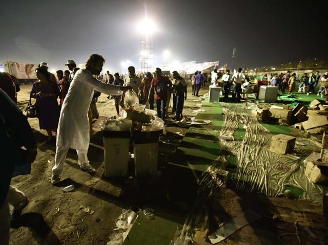 People throw garbage in the over flooded bins after the end of 3 day World Cultural Festival on the banks of Yamuna. (Arun Sharma/Hindustan Times) 