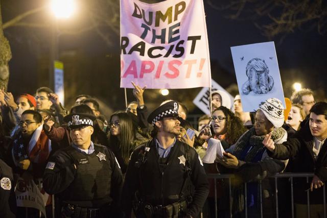 Demonstrators taunt supporters of Donald Trump as they leave a rally at the University of Illinois . (AFP) Demonstrators taunt supporters of Donald Trump as they leave a rally at the University of Illinois . (AFP)