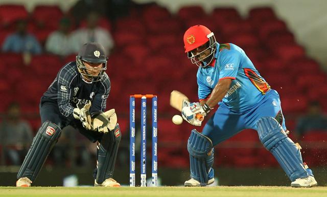 Afghanistan's Mohammad Shahzad (R) is watched by Scotland's wicketkeeper Matt Cross as he plays a shot during the ICC World T20 cricket tournament match between Afghanistan and Scotland. (AFP Photo) Afghanistan's Mohammad Shahzad (R) is watched by Scotland's wicketkeeper Matt Cross as he plays a shot during the ICC World T20 cricket tournament match between Afghanistan and Scotland. (AFP Photo)