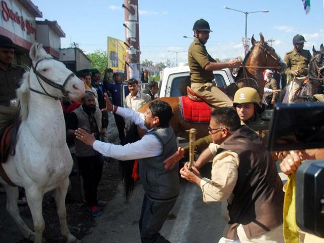 BJP MLA Ganesh Joshi hitting a horse during a party rally at Vidhan Sabha in Dehradun, India, on Monday, March 14, 2016.(Vinay Santosh Kumar / HT Photo)