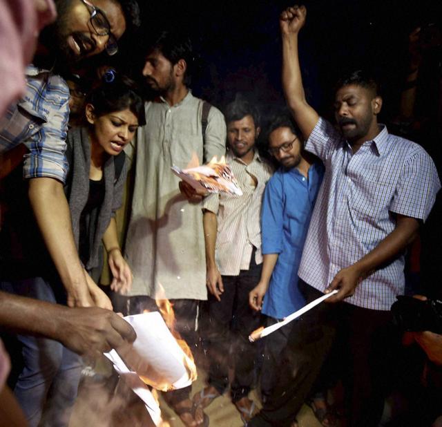 Akhil Bharatiya Vidyarthi Parishad rebels, who left the RSS' student outfit citing differences over the handling of the JNU row, burn a copy of the ancient legal text Manusmriti despite the varsity administration denying permission for the same, in New Delhi. (PTI) Akhil Bharatiya Vidyarthi Parishad rebels, who left the RSS' student outfit citing differences over the handling of the JNU row, burn a copy of the ancient legal text Manusmriti despite the varsity administration denying permission for the same, in New Delhi. (PTI)
