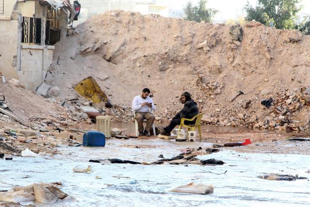 Rebel fighters from 'The First Regiment', part of the Free Syrian Army, rest behind a sand barricade. (Reuters Photo) Rebel fighters from 'The First Regiment', part of the Free Syrian Army, rest behind a sand barricade. (Reuters Photo)