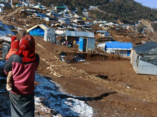 This photo taken on January 21, 2016 shows a woman and her child near temporary shelters in the Nepalese village of Laprak. Eleven months after a massive earthquake hit Nepal, thousands of survivors are awaiting government help to rebuild their homes. (AFP FILE) This photo taken on January 21, 2016 shows a woman and her child near temporary shelters in the Nepalese village of Laprak. Eleven months after a massive earthquake hit Nepal, thousands of survivors are awaiting government help to rebuild their homes. (AFP FILE)