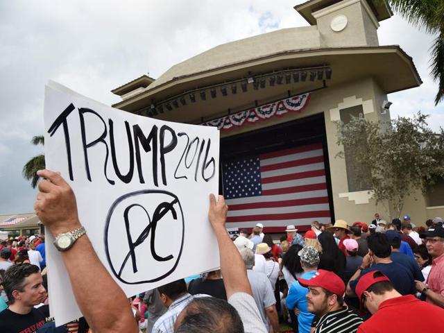 Trump supporters hold signs as they enter the venue prior to a rally for Republican presidential candidate Donald Trump. (AFP) Trump supporters hold signs as they enter the venue prior to a rally for Republican presidential candidate Donald Trump. (AFP)