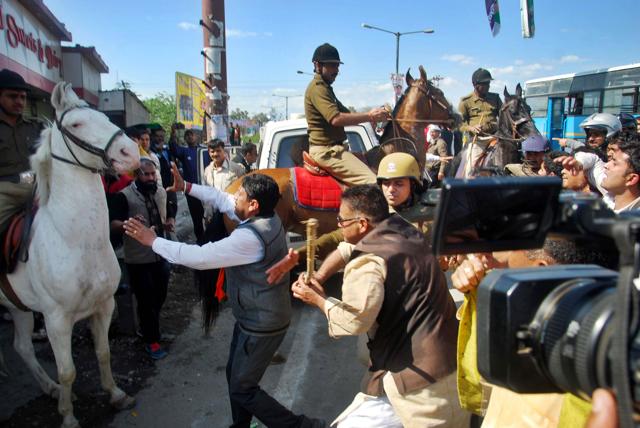MLA Ganesh Joshi beating a horse during a BJP rally at Uttarakhand assembly in Dehradun on Monday. (Vinay Santosh Kumar/HT Photo) MLA Ganesh Joshi beating a horse during a BJP rally at Uttarakhand assembly in Dehradun on Monday. (Vinay Santosh Kumar/HT Photo)