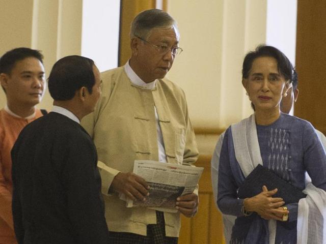 Myanmar lower house parliament speaker Win Myint, Htin Kyaw (centre) and Aung San Suu Kyi arrive at the lower house of Parliament in Naypyidaw.(AFP) Myanmar lower house parliament speaker Win Myint, Htin Kyaw (centre) and Aung San Suu Kyi arrive at the lower house of Parliament in Naypyidaw.(AFP)