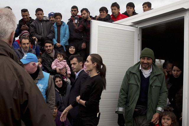 Angelina Jolie, center, gestures in front of refugees and migrants during her visit at the port of Piraeus near Athens. (AP) Angelina Jolie, center, gestures in front of refugees and migrants during her visit at the port of Piraeus near Athens. (AP)