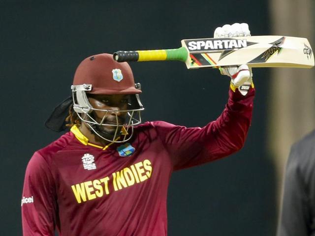 Gayle raises his bat after reaching his half-century. (AP Photo) Gayle raises his bat after reaching his half-century. (AP Photo)