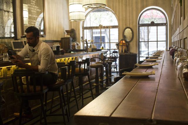 The interiors of Farmer & Sons features French window set in metallic grey walls, a high ceiling and large chandeliers suspended over the bar. (Resha Gandhi/ HT Photo) The interiors of Farmer & Sons features French window set in metallic grey walls, a high ceiling and large chandeliers suspended over the bar. (Resha Gandhi/ HT Photo)