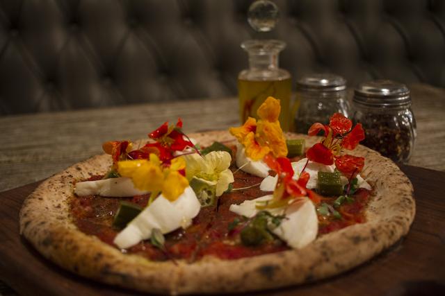 The Malouf Pizza, served Romano style, had a creamy burrata, a tangy tomato base and unexpected sweetness from ladies fingers. (Resha Gandhi/ HT Photo) The Malouf Pizza, served Romano style, had a creamy burrata, a tangy tomato base and unexpected sweetness from ladies fingers. (Resha Gandhi/ HT Photo)