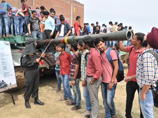 Students take a look at a T-72 M tank during the army exhibition on Wednesday. (Pardeep Pandit/HT Photo)