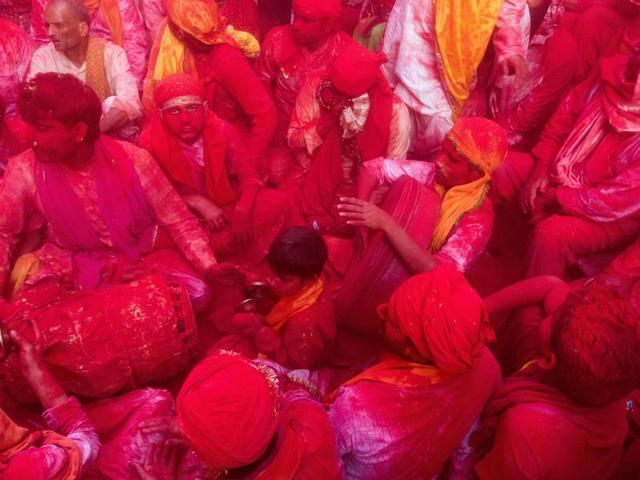 A few days later comes Lath-mar Holi. Tradition has it that folks from Nandgaon (from Lord Krishna’s cowherd clan) would visit Radha’s hometown, Barsana, where women (gopis) would chase them away with lathis (sticks).  (AFP) 