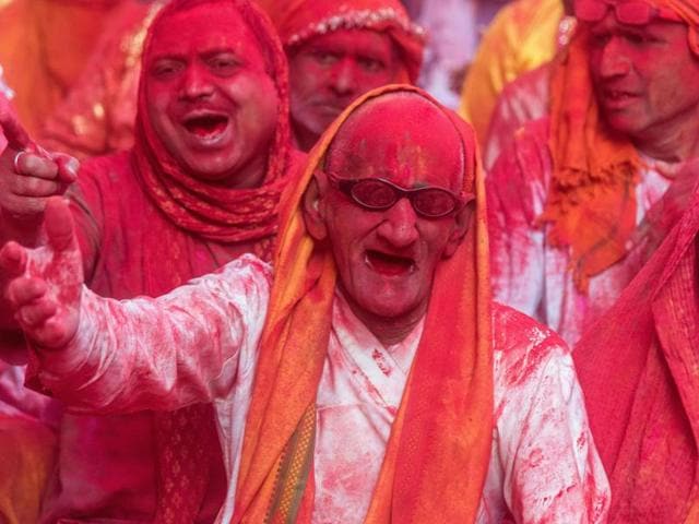 Devotees covered in gulal during the Holi festivities at the Radha Rani temple in Barsana on March 16, 2016.  (AFP) 