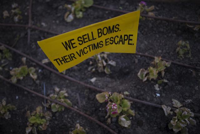 A small placard stands among plants after being stuck there by a protester in at the end of a protest in Madrid against the European Union proposals to send refugees back to Turkey. (AP) A small placard stands among plants after being stuck there by a protester in at the end of a protest in Madrid against the European Union proposals to send refugees back to Turkey. (AP)