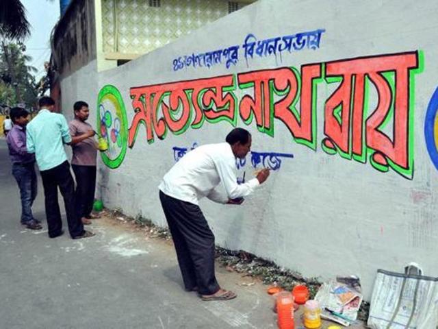 An artist makes graffiti for a Trinamool Congress (TMC) candidate ahead of the assembly elections at Balurghat, in South Dinajpur district of West Bengal. (PTI/ Photo for representation) An artist makes graffiti for a Trinamool Congress (TMC) candidate ahead of the assembly elections at Balurghat, in South Dinajpur district of West Bengal. (PTI/ Photo for representation)