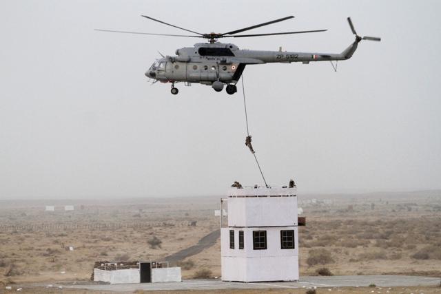 A soldier is dropped on a rooftop from a helicopter during exercise 'Iron Fist'. (AP Photo) A soldier is dropped on a rooftop from a helicopter during exercise 'Iron Fist'. (AP Photo)