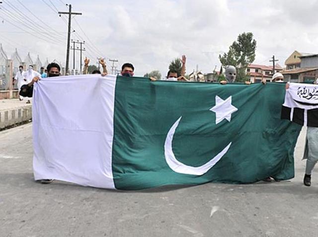 Masked protesters carrying a large Pakistan flag on the street in Jammu and Kashmir. (Waseem Andrabi/HT File Photo) Masked protesters carrying a large Pakistan flag on the street in Jammu and Kashmir. (Waseem Andrabi/HT File Photo)