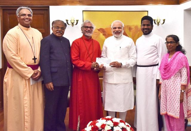 Prime Minister Narendra Modi (centre) with Christian missionaries and PJ Kurien, deputy chairman of Rajya Sabha (second from left), in New Delhi. (PTI) Prime Minister Narendra Modi (centre) with Christian missionaries and PJ Kurien, deputy chairman of Rajya Sabha (second from left), in New Delhi. (PTI)