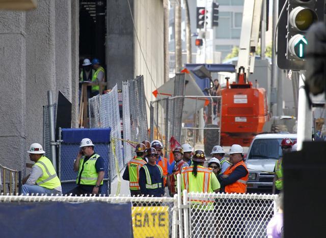 Construction workers gather at the base of the Wilshire Grand Tower on South Figueroa Street where a worker fell to his death on Thursday. (AP Photo) Construction workers gather at the base of the Wilshire Grand Tower on South Figueroa Street where a worker fell to his death on Thursday. (AP Photo)