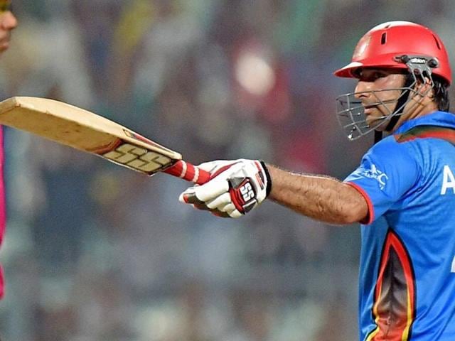 Asghar Stanikzai raises his bat after completing his half-century. (PTI) Asghar Stanikzai raises his bat after completing his half-century. (PTI)
