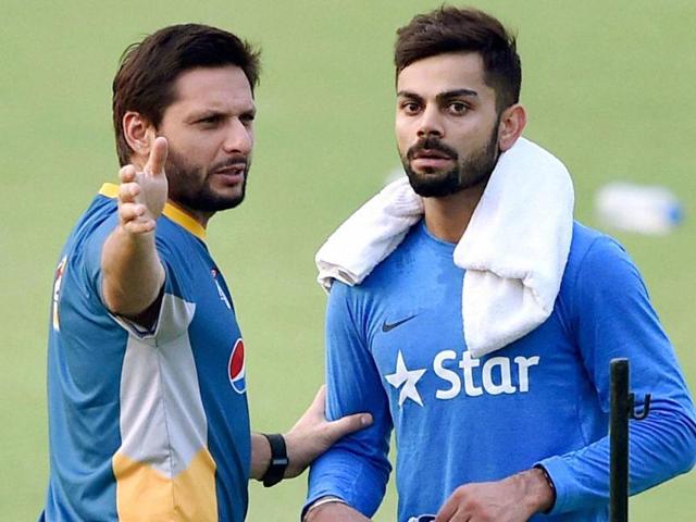 Pakistan captain Shahid Afridi with Virat Kohli during their training session at the Eden Gardens in Kolkata. (Ashok Nath Dey/HT Photo) Pakistan captain Shahid Afridi with Virat Kohli during their training session at the Eden Gardens in Kolkata. (Ashok Nath Dey/HT Photo)