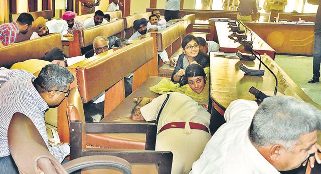 Officers hiding under tables during the mock drill at Bachhat Bhawan, DC office, in Ludhiana on Friday. (Sikander Singh Chopra/HT Photo)
