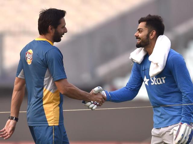 Pakistan captain Shahid Afridi shakes hands with India’s Virat Kohli during a practice session at Eden Gardens in Kolkata ahead of their World T20 clash on March 19. (Ajay Aggarwal/HT Photo )