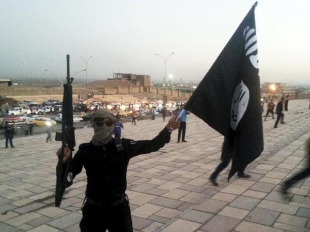 Islamist State fighters hold their flags during a military parade along the streets of northern Raqqa province in 2014. (Reuters file) Islamist State fighters hold their flags during a military parade along the streets of northern Raqqa province in 2014. (Reuters file)