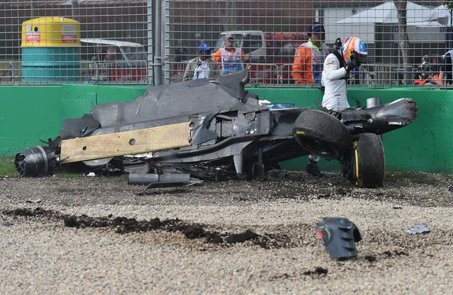Fernando Alonso walks away from his mangled McLaren. (AP) Fernando Alonso walks away from his mangled McLaren. (AP)