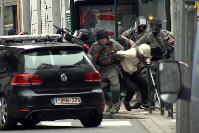 In this framegrab taken from VTM, armed police officers escort a suspect to a police vehicle during a raid in the Molenbeek neighborhood of Brussels, Belgium, Friday March 18, 2016. (AP Photo) In this framegrab taken from VTM, armed police officers escort a suspect to a police vehicle during a raid in the Molenbeek neighborhood of Brussels, Belgium, Friday March 18, 2016. (AP Photo)