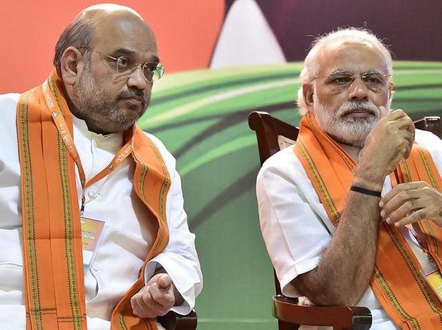 Prime Minister Narendra Modi talks with BJP president Amit Shah at party's National Executive meet, in New Delhi on Saturday. (PTI Photo) Prime Minister Narendra Modi talks with BJP president Amit Shah at party's National Executive meet, in New Delhi on Saturday. (PTI Photo)