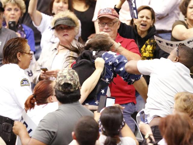 A member of the audience (R) throws a punch at a protestor as Republican Presidential candidate Donald Trump speaks during a campaign event in Tucson, Arizona March 19, 2015. REUTERS/Sam Mircovich (REUTERS) A member of the audience (R) throws a punch at a protestor as Republican Presidential candidate Donald Trump speaks during a campaign event in Tucson, Arizona March 19, 2015. REUTERS/Sam Mircovich (REUTERS)