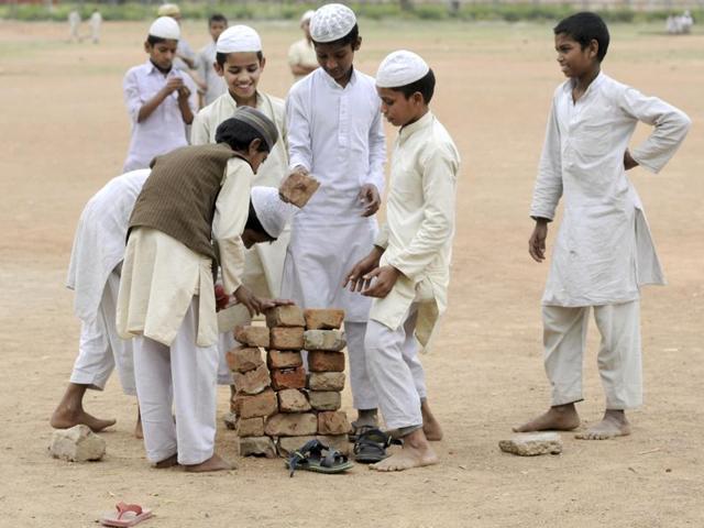 As the T20 World Cup is being aired across TV sets across the country, young boys enjoy a game of cricket as their Madrasa does not have a TV set. (Sunil Ghosh/HT Photo)