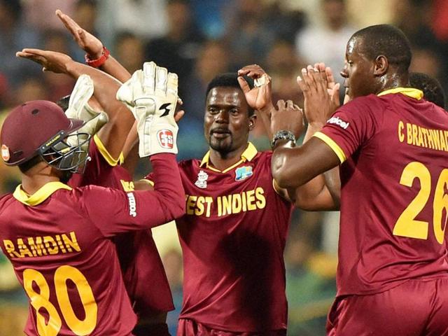 West Indies’ wicketkeeper Denesh Ramdin, right, breaks the stumps to run-out Sri Lanka's Dinesh Chandimal.(AP Photo)