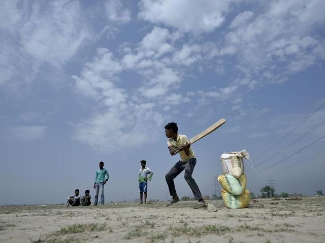 Children play cricket near the banks of Yamuna. (Ravi Choudhary/HT Photo)