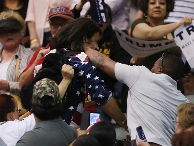 Trump protester Bryan Sanders, center left, is punched by a Trump supporter as he is escorted out of Republican presidential candidate Donald Trump's rally at the Tucson Arena in downtown Tucson, Arizona, Saturday, March 19, 2016. (AP) Trump protester Bryan Sanders, center left, is punched by a Trump supporter as he is escorted out of Republican presidential candidate Donald Trump's rally at the Tucson Arena in downtown Tucson, Arizona, Saturday, March 19, 2016. (AP)