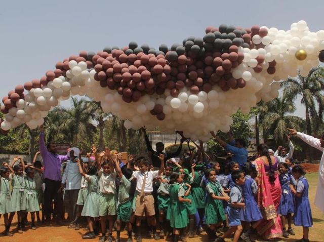 Schoolchildren release a 30-ft sparrow shaped balloon at Dharavi on Sunday.