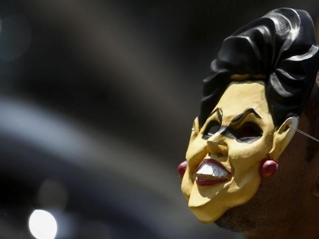 A demonstrator wearing a mask of Brazilian President Dilma Rousseff rallies in support of her impeachment at Paulista Avenue, in Sao Paulo, Brazil. (AFP)