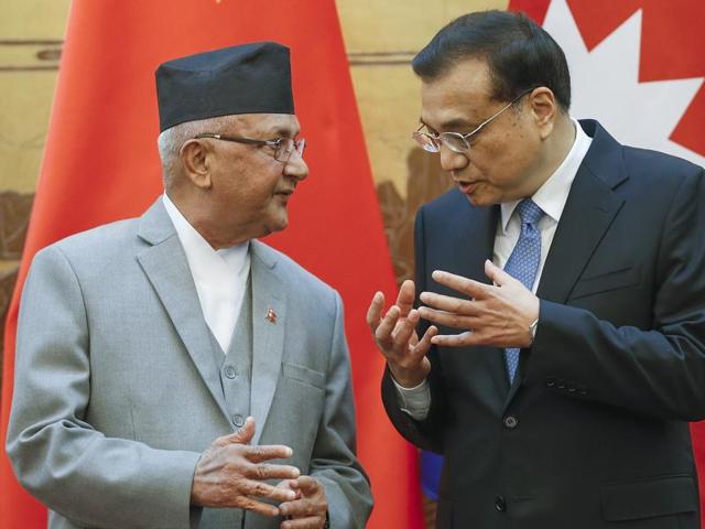 Chinese Premier Li Keqiang (right) speaks with Nepalese Prime Minister KP Sharma Oli during a signing ceremony at the Great Hall of the People in Beijing on Monday.(AFP)