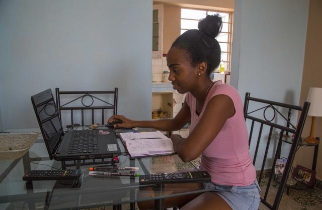 Yolanda Mauri works on her laptop at her home in Havana, Cuba. For Mauri and hundreds of thousands of black Cubans, Barack Obama isn’t just the first U.S. leader to visit their country in nearly nine decades. He’s a black man whose rise to the world’s most powerful job is a source of pride and inspiration. (AP Photo) Yolanda Mauri works on her laptop at her home in Havana, Cuba. For Mauri and hundreds of thousands of black Cubans, Barack Obama isn’t just the first U.S. leader to visit their country in nearly nine decades. He’s a black man whose rise to the world’s most powerful job is a source of pride and inspiration. (AP Photo)