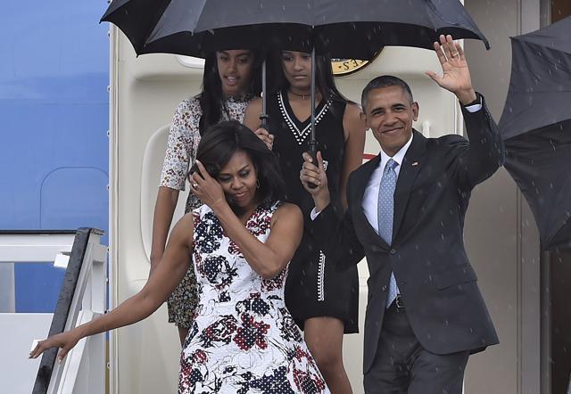 US President Barack Obama waves next to First Lady Michelle Obama (L) and their daughters Malia (L, behind) and Sasha upon their arrival at Jose Marti international airport in Havana (AFP) US President Barack Obama waves next to First Lady Michelle Obama (L) and their daughters Malia (L, behind) and Sasha upon their arrival at Jose Marti international airport in Havana (AFP)