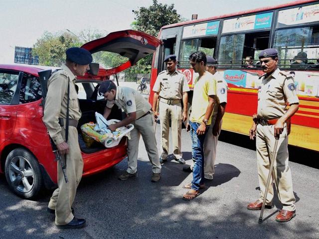 Police check a vehicle after a high alert was announced in Ahmedabad on Sunday. (PTI Photo)