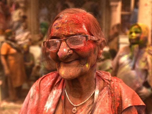 A widow smeared in Gulal takes part in Holi celebrations at Gopinath temple.The widows were highly excited as first time they played Holi inside any temple, marking their further social assimilation. (Ajay Aggarwal/HT Photo)
